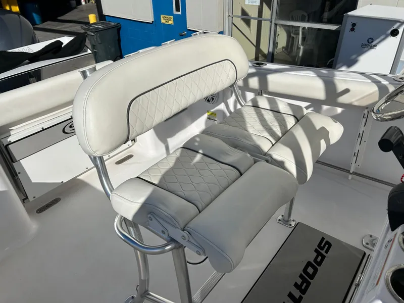 Slide: The Image of 2020 Sportsman Open 232 Center Console boat with white cushioned seating and stainless steel frame. - 11