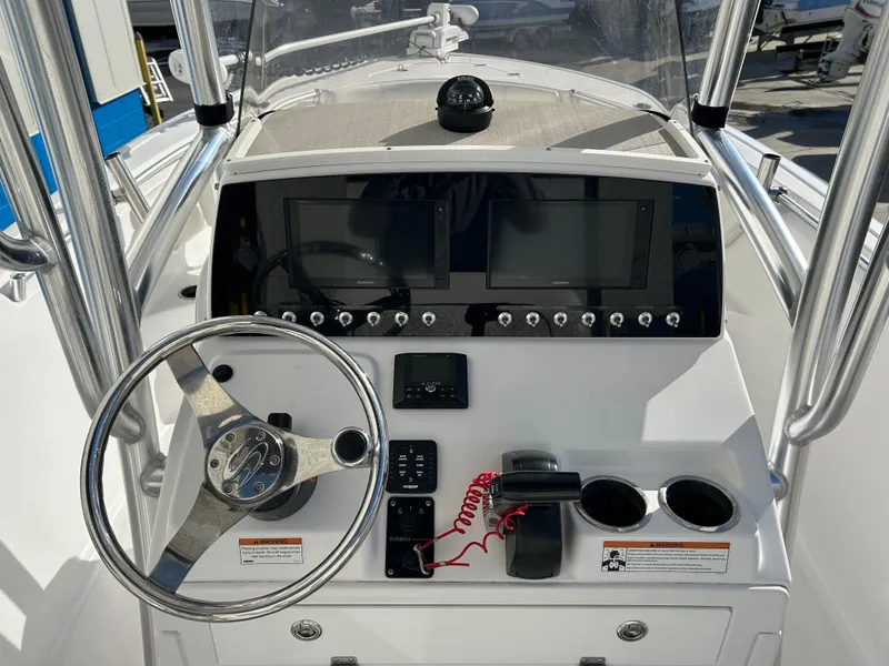 Slide: The Image of 2020 Sportsman Open 232 Center Console boat dashboard with steering wheel and electronic displays. - 12