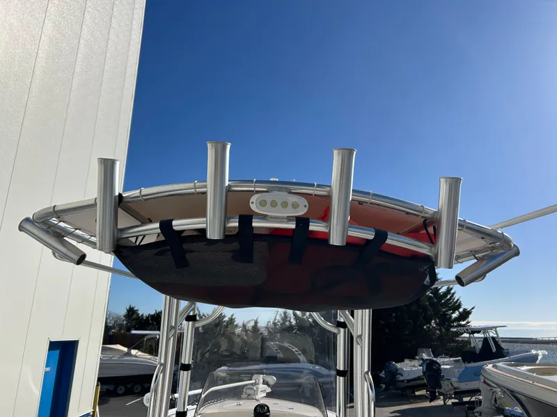 Slide: The Image of 2020 Sportsman Open 232 Center Console boat with T-top and rod holders. - 13