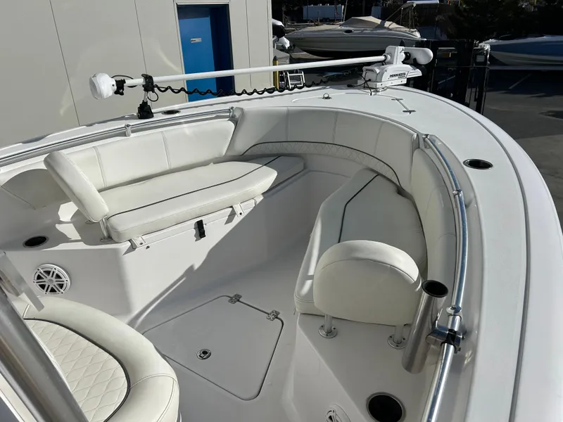 Slide: The Image of 2020 Sportsman Open 232 Center Console boat with white seating and stainless steel railings. - 14