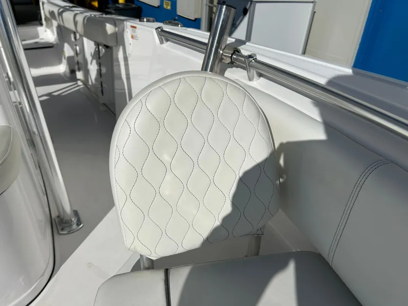 Slide: The Image of 2020 Sportsman Open 232 Center Console boat seat with white quilted upholstery. - 17