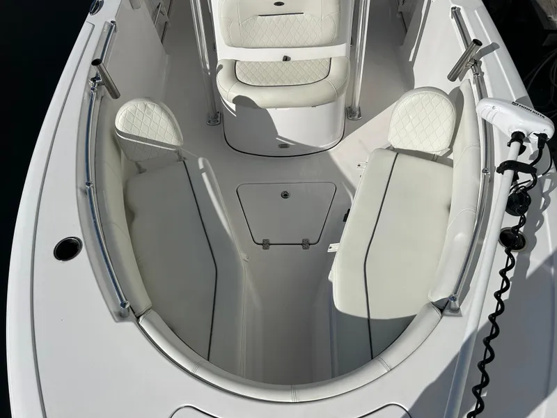 Slide: The Image of 2020 Sportsman Open 232 Center Console boat interior with white seating and storage compartments. - 18