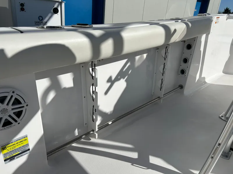 Slide: The Image of 2020 Sportsman Open 232 Center Console boat interior with rod holders and speaker. - 24