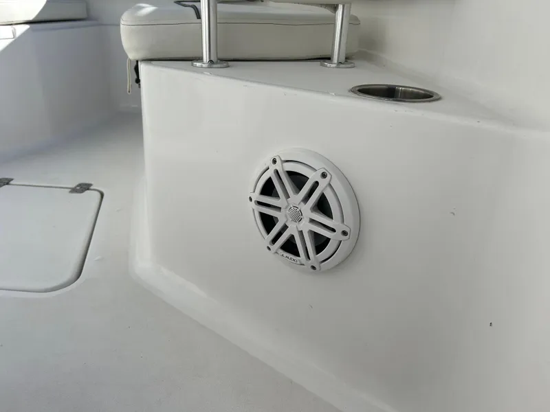 Slide: The Image of 2020 Sportsman Open 232 Center Console boat interior with speaker and cup holder. - 27