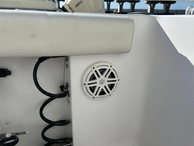 Slide: The Image of 2020 Sportsman Open 232 Center Console boat interior with speaker and coiled cable. - 29