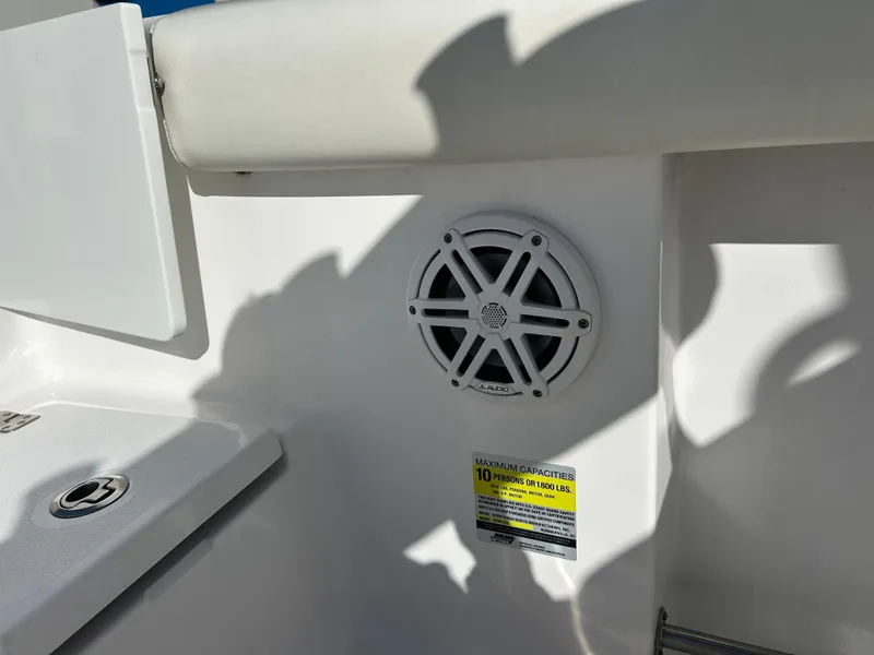 Slide: The Image of 2020 Sportsman Open 232 Center Console boat interior with speaker and safety label. - 30