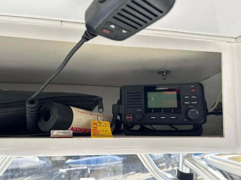 Slide: The Image of 2020 Sportsman Open 232 Center Console with Garmin radio and microphone in storage compartment. - 31