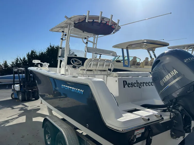 Slide: The Image of 2020 Sportsman Open 232 Center Console boat with Yamaha engine, parked outdoors. - 4