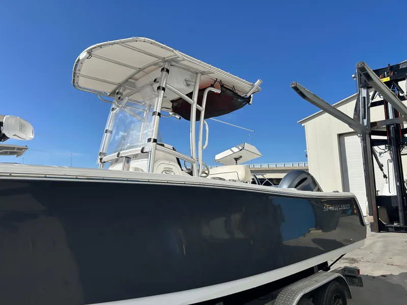 Slide: The Image of 2020 Sportsman Open 232 Center Console boat with T-top, parked outdoors. - 5