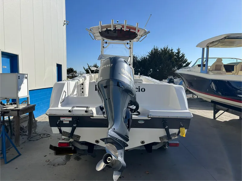 Slide: The Image of 2020 Sportsman Open 232 Center Console boat with outboard motor, parked outdoors. - 6