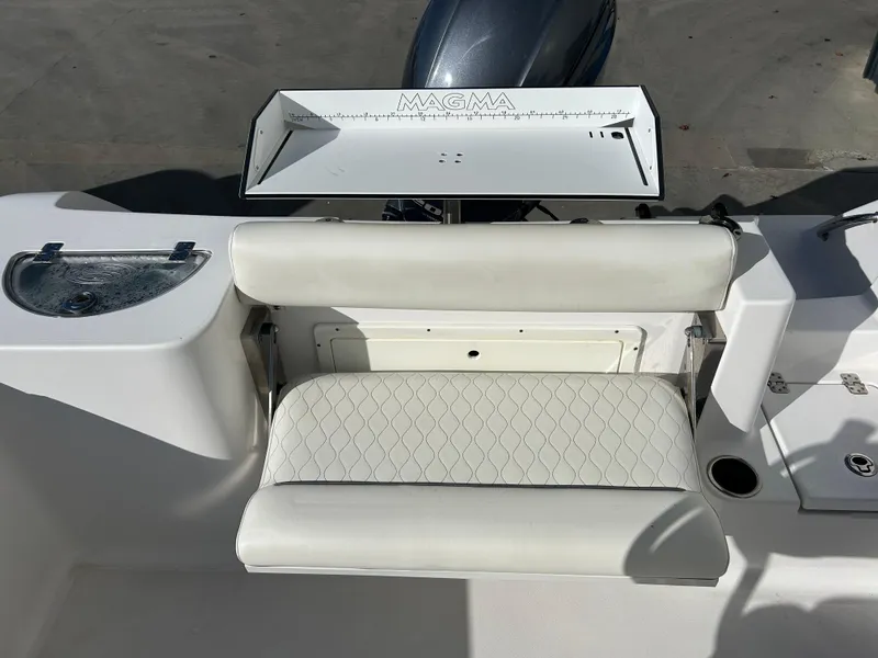 Slide: The Image of 2020 Sportsman Open 232 Center Console boat with white seating and Magma grill. - 8