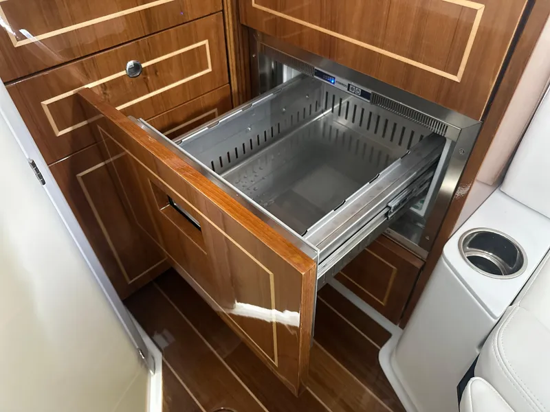 Slide: The Image of Luxury wooden cabinetry with open drawer in 2025 HCB 42 Lujo boat interior. - 10