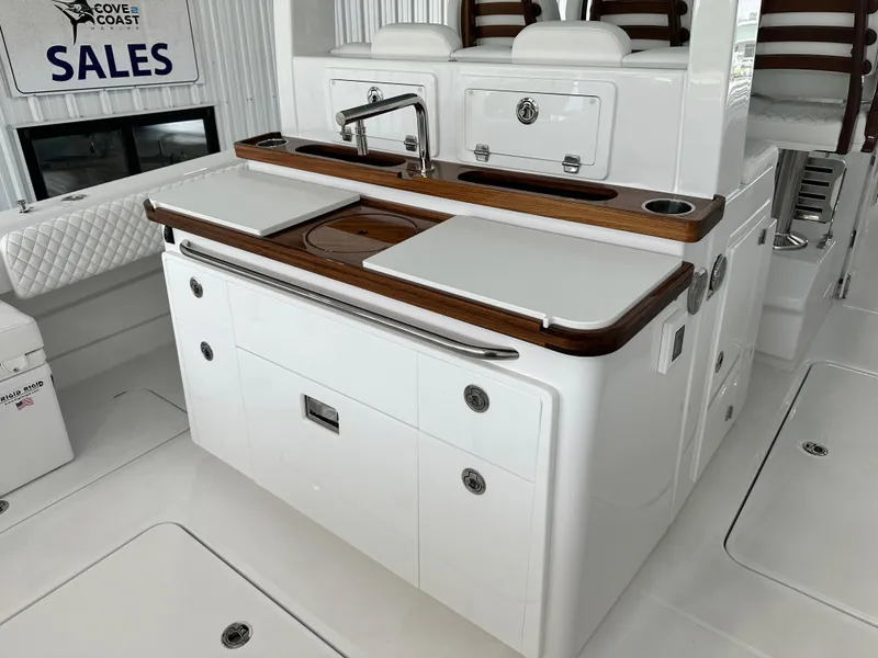 Slide: The Image of 2025 HCB 42 Lujo boat interior with sleek kitchen area and modern amenities. - 16