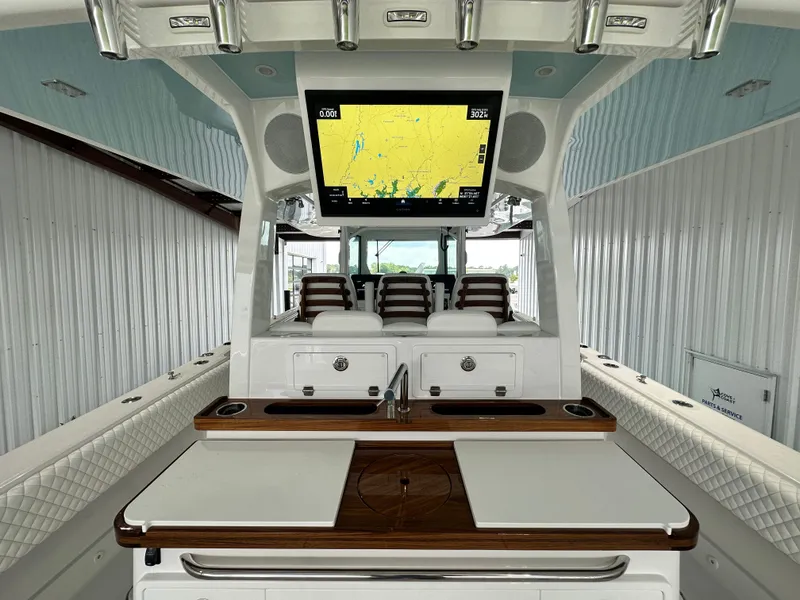 Slide: The Image of 2025 HCB 42 Lujo boat interior with navigation screen and seating. - 5
