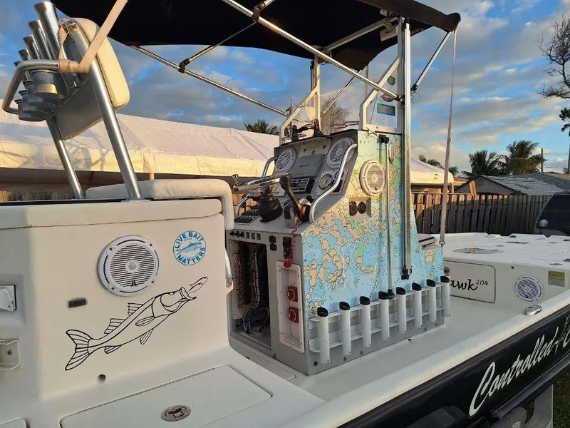 Slide: The Image of Bay Hawk 204 boat, 1992 model, featuring a detailed control panel and fishing rod holders. - 11