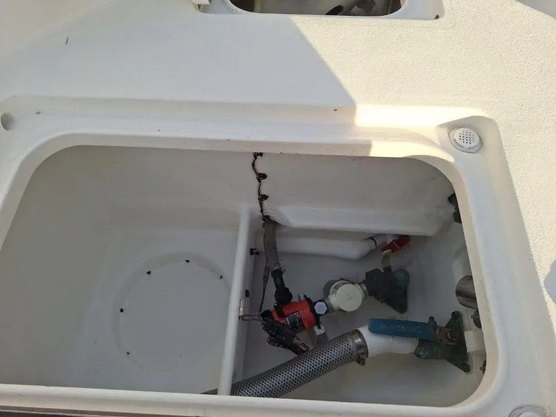 Slide: The Image of Bay Hawk 204 boat compartment with hoses and fittings, 1992 model. - 13