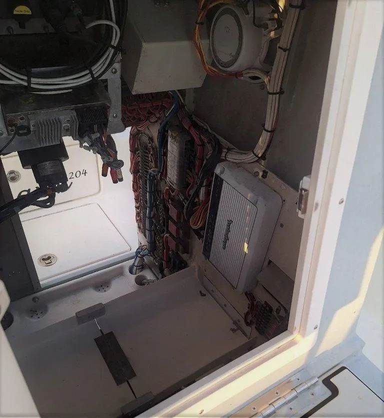 Slide: The Image of Interior view of a 1992 Bay Hawk 204 boat, showcasing wiring and components. - 18