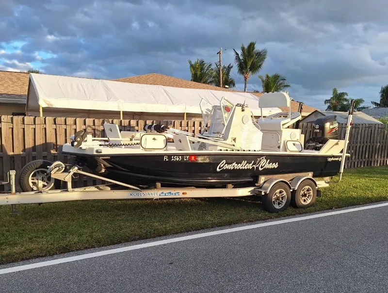 Slide: The Image of Bay Hawk 204 boat on trailer, 1992 model, parked beside a road under cloudy sky. - 3