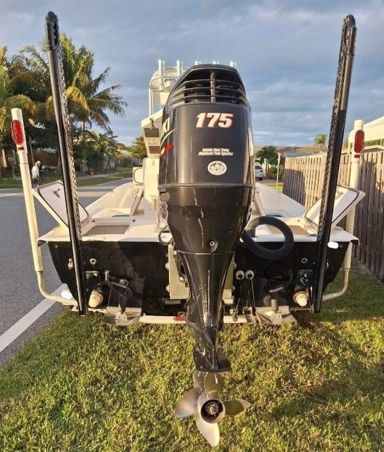 Slide: The Image of Bay Hawk 204 boat, 1992 model, with a 175 HP outboard motor, parked on grass. - 7
