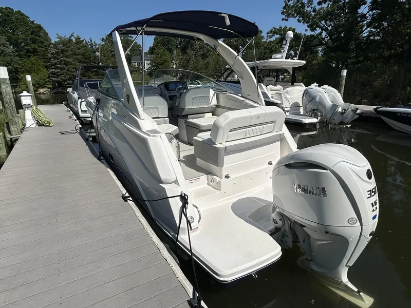 Slide: The Image of 2025 Regal 26 XO boat docked, featuring Yamaha 350 V8 engine, sleek design, and spacious seating. - 1