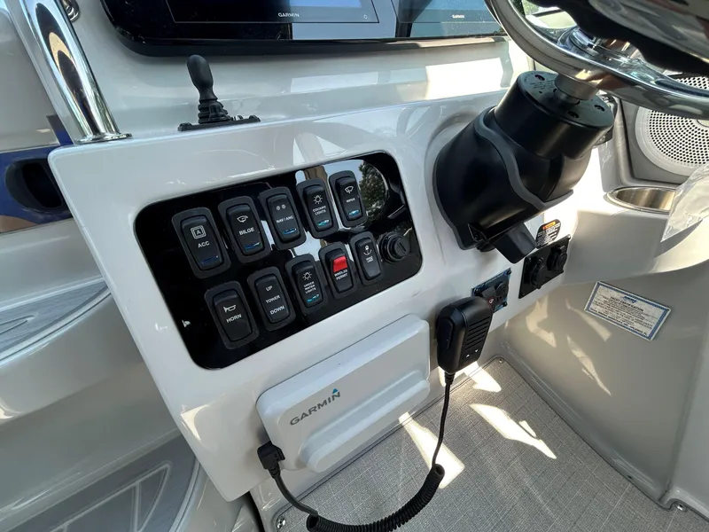 Slide: The Image of Control panel of 2025 Regal 26 XO boat with Garmin system and various switches. - 13