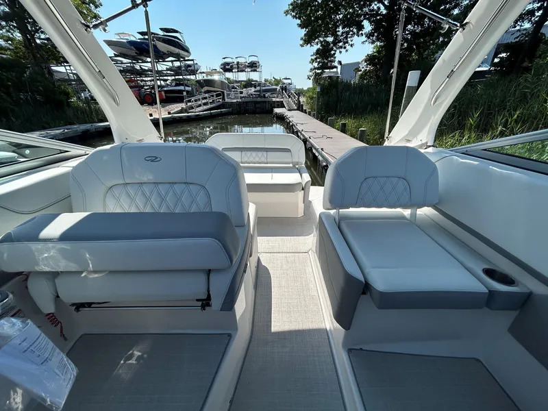 Slide: The Image of Interior of 2025 Regal 26 XO boat with luxurious seating and dock view. - 15