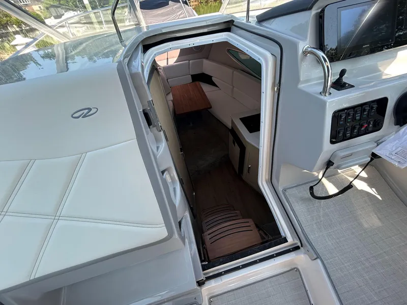 Slide: The Image of Interior view of 2025 Regal 26 XO boat, featuring seating and control panel. - 16