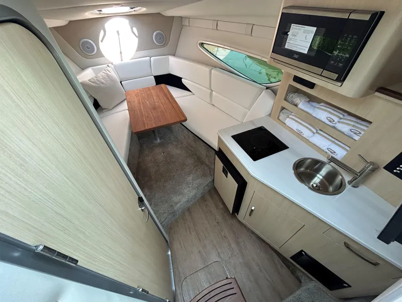 Slide: The Image of Luxurious interior of 2025 Regal 26 XO boat with kitchenette and seating area. - 17