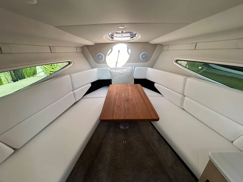 Slide: The Image of Luxurious interior of 2025 Regal 26 XO boat with elegant seating and wooden table. - 18