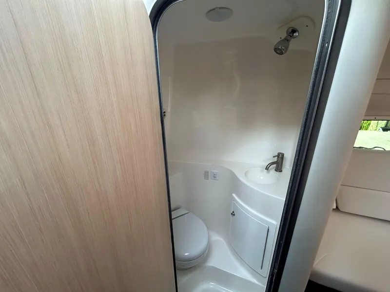 Slide: The Image of 2025 Regal 26 XO boat bathroom with shower, sink, and toilet. - 19