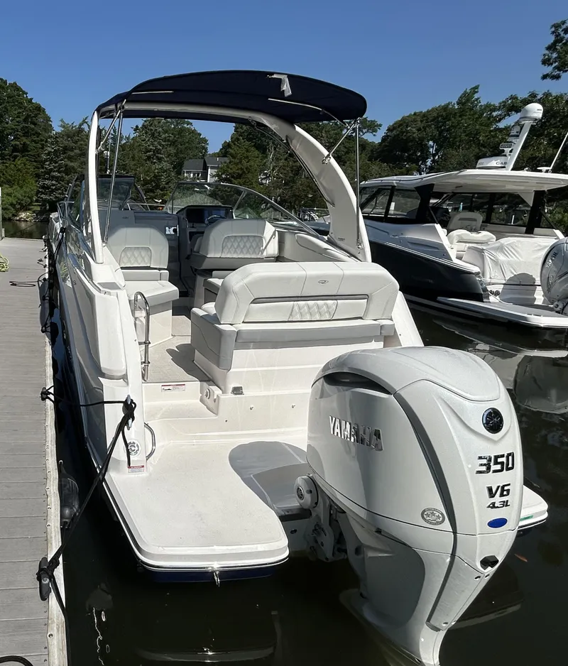 Slide: The Image of 2025 Regal 26 XO boat with Yamaha 350 V6 engine docked in marina. - 2