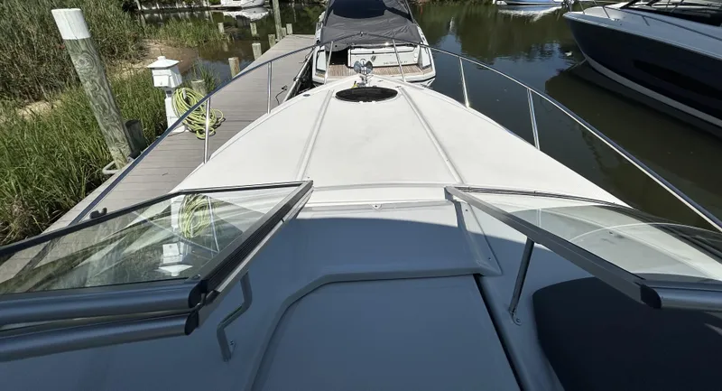Slide: The Image of 2025 Regal 26 XO boat docked, viewed from the bow with open windshield. - 25