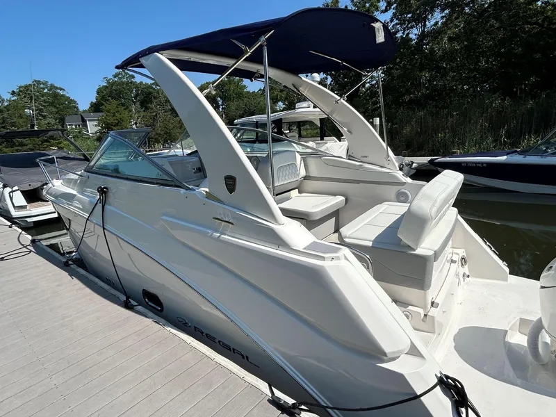 Slide: The Image of 2025 Regal 26 XO boat docked, featuring sleek design and comfortable seating. - 3