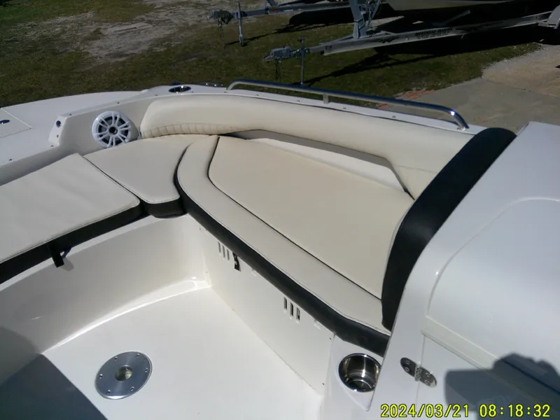Slide: The Image of 2022 Stingray 212SC boat interior, featuring sleek white seating and modern design elements. - 17