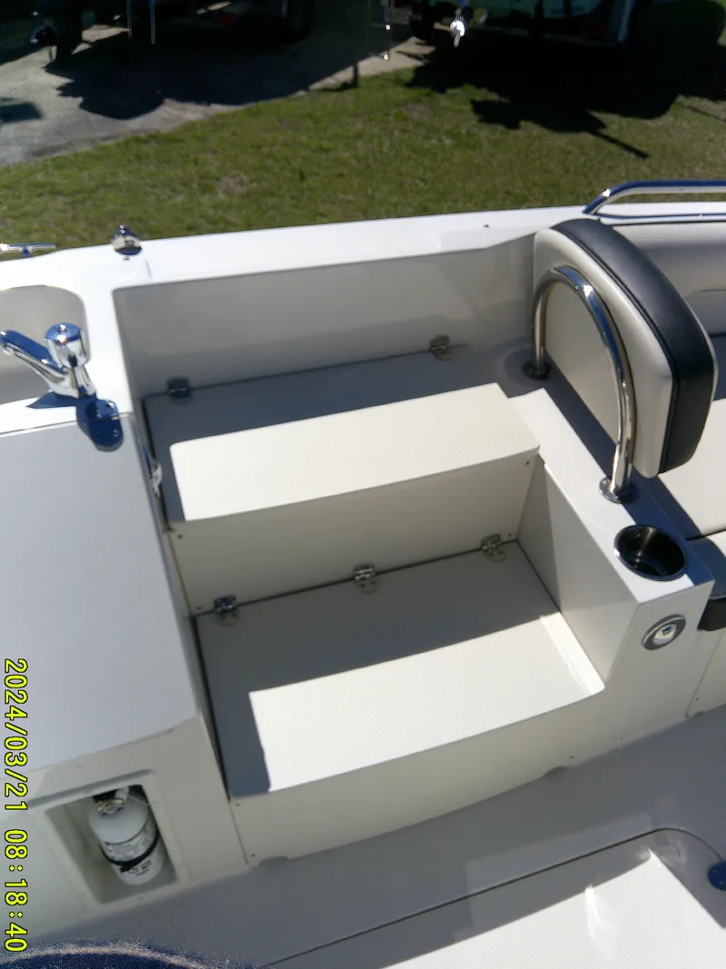 Slide: The Image of 2022 Stingray 212SC boat interior with seating and steps, featuring sleek design and modern amenities. - 19