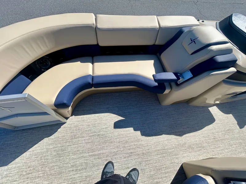 Slide: The Image of 2025 Berkshire 23CL STS 3.0 boat interior with beige and navy seating. - 11