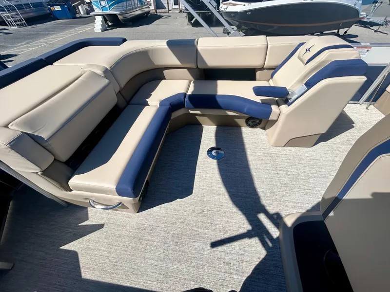 Slide: The Image of 2025 Berkshire 23CL STS 3.0 boat interior with beige and navy seating. - 14