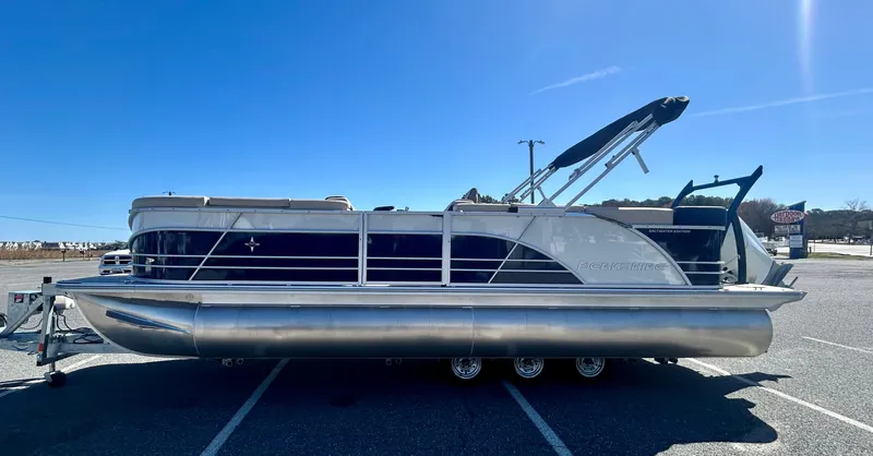 Slide: The Image of 2025 Berkshire 23CL STS 3.0 pontoon boat parked under clear blue sky. - 2