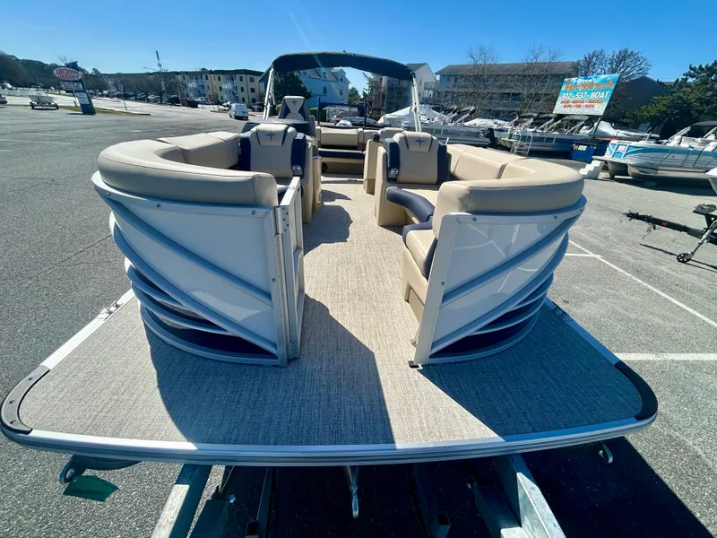 Slide: The Image of 2025 Berkshire 23CL STS 3.0 pontoon boat with spacious seating, parked outdoors. - 4