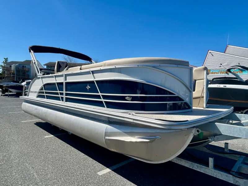 Slide: The Image of 2025 Berkshire 23CL STS 3.0 pontoon boat parked under clear blue sky. - 5