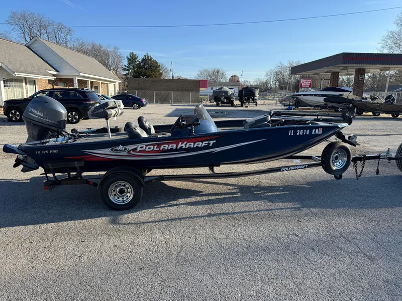 Slide: The Image of 2014 Polar Kraft Bass TX 175 Pro boat on trailer in parking lot. - 10
