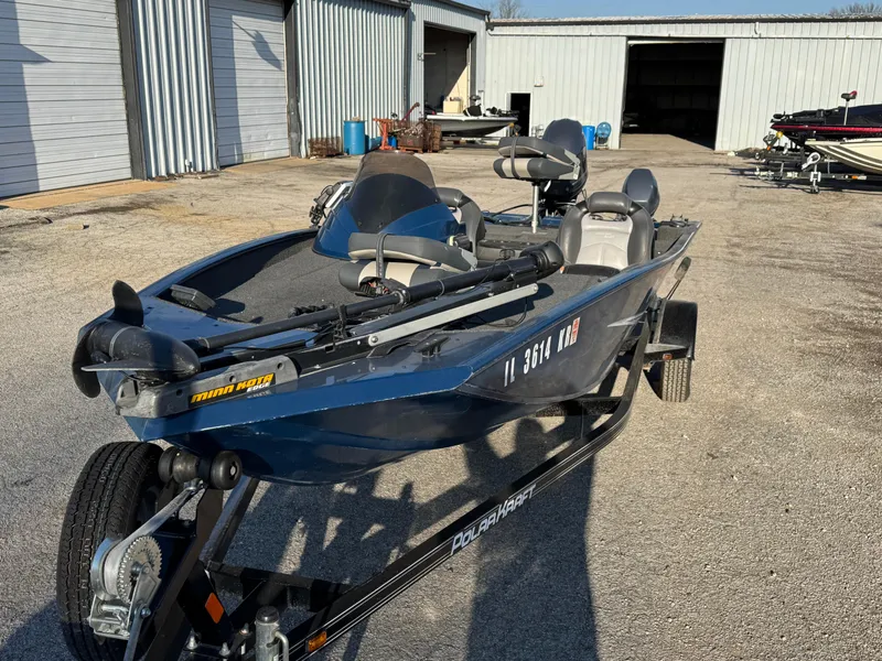 Slide: The Image of 2014 Polar Kraft Bass TX 175 Pro boat on trailer in outdoor storage area. - 13