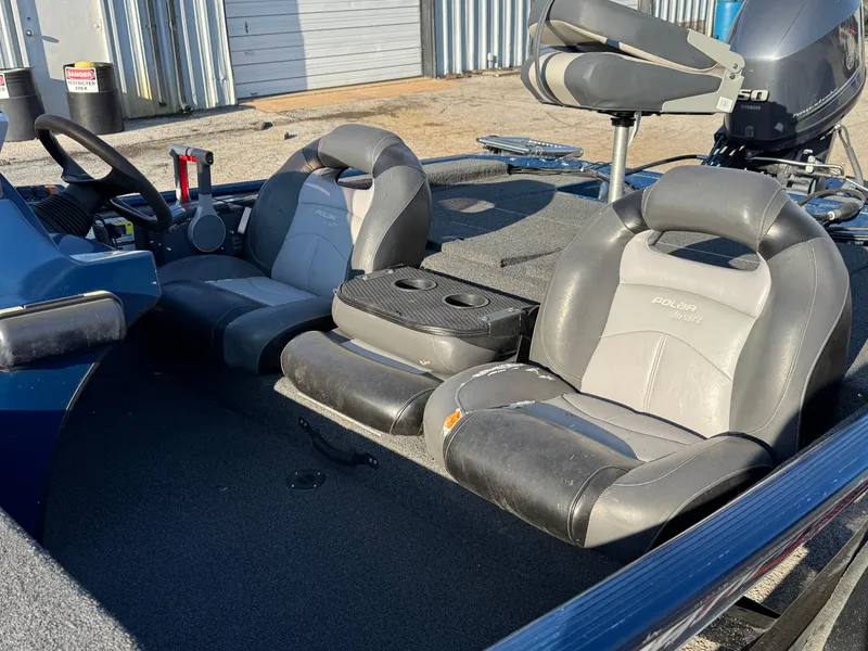 Slide: The Image of 2014 Polar Kraft Bass TX 175 Pro boat interior with gray seating and steering console. - 14