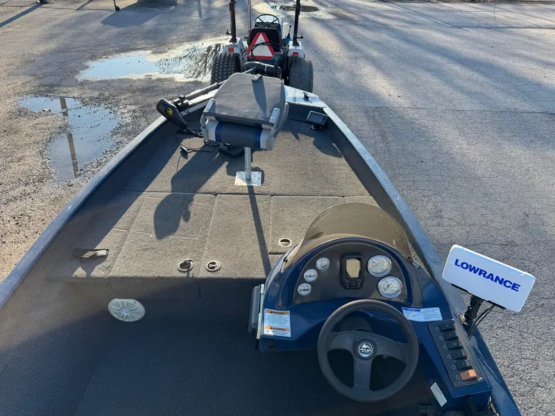 Slide: The Image of 2014 Polar Kraft Bass TX 175 Pro boat interior with Lowrance equipment, parked on pavement. - 19