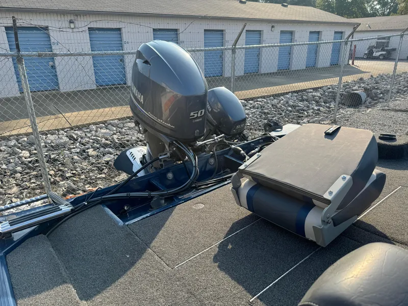 Slide: The Image of 2014 Polar Kraft Bass TX 175 Pro boat with Yamaha 50 engine, parked near storage units. - 4