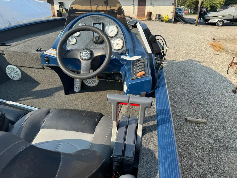 Slide: The Image of 2014 Polar Kraft Bass TX 175 Pro boat interior with steering wheel and control panel. - 5