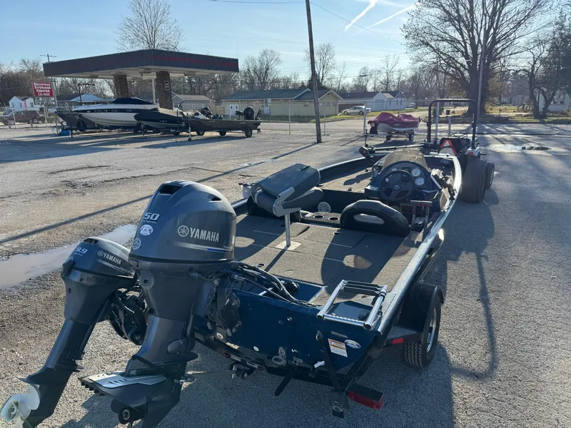 Slide: The Image of 2014 Polar Kraft Bass TX 175 Pro boat with Yamaha engine on trailer in parking lot. - 9