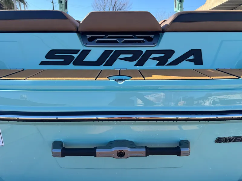 Slide: The Image of 2025 Supra SL 450 boat rear view with logo and sleek design. - 11