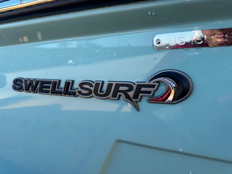 Slide: The Image of 2025 Supra SL 450 with SwellSurf logo on light blue exterior. - 14
