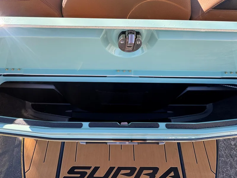 Slide: The Image of Open trunk of 2025 Supra SL 450 with brown interior and branded mat. - 16